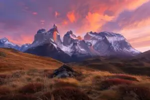 A mountain range with a beautiful orange sky in the background