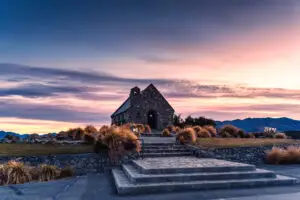 Magnificent holy the Church of the good shepherd with colorful sunrise sky on shore of Lake Tekapo at Canterbury, South Island of New Zealand