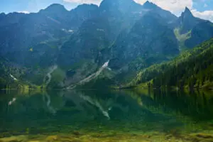 Amazing view on mountains range near beautiful lake at summer day. Tatra National Park in Poland. Panoramic view on Morskie Oko or Sea Eye lake in Five lakes valley